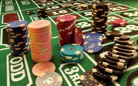 Live Sic Bo table at ezbet login with dealer, dice cage, and betting interface displayed on screen